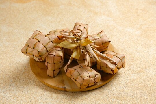 Ketupat is a traditional Indonesian food. made from boiled rice wrapped in woven young coconut leaves, usually eat when Eid Mubarak. served with Curry or Satay.