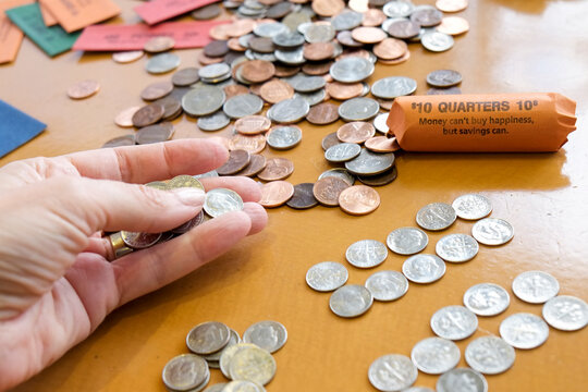 New York City, NY.  Hand counting coins money savings and budgeting concept