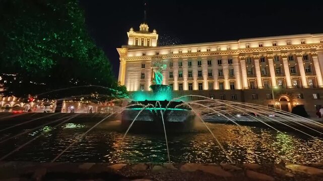 Sofia, Bulgaria - 9.20.2025. Illuminated fountain nearby the Presidential Palace of the Republic of Bulgaria. Stunning cityscape with historic architecture and glowing lights