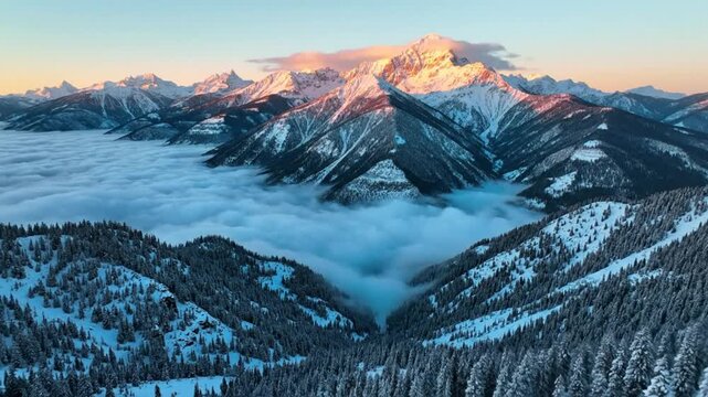 Stunning aerial view of majestic snow-capped mountains peaking above a sea of clouds during sunrise