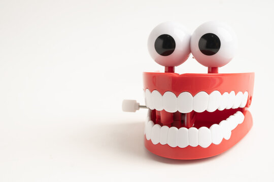 Funny red teeth with eye toy denture model for dental health care.