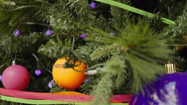 Close view of Christmas ornaments and ribbons on holiday tree in Miami