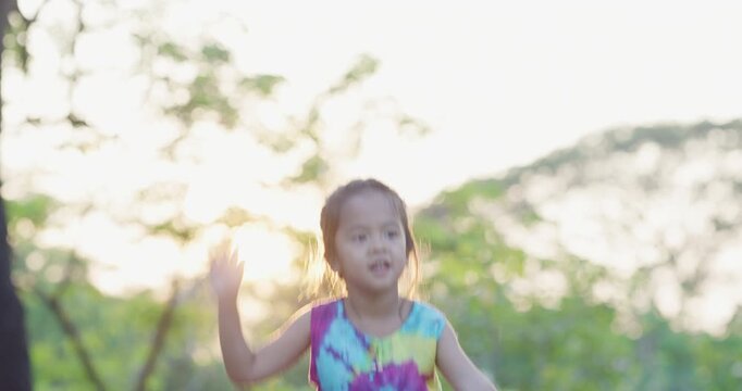 Adorable kids girl enjoy dancing outdoor city park sunset light