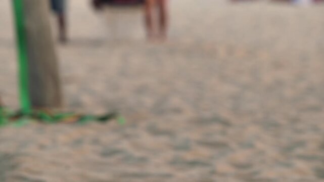 slow motion of man on slack line at beach