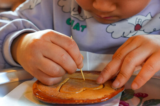 Child's Hands Carefully Carving Heart Shaped Dalgona Candy with a Toothpick in Korea