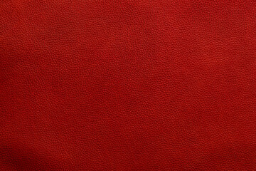 Fototapeta premium Close up view of red textured surface showing details of leather material in natural light capturing its unique pattern and color