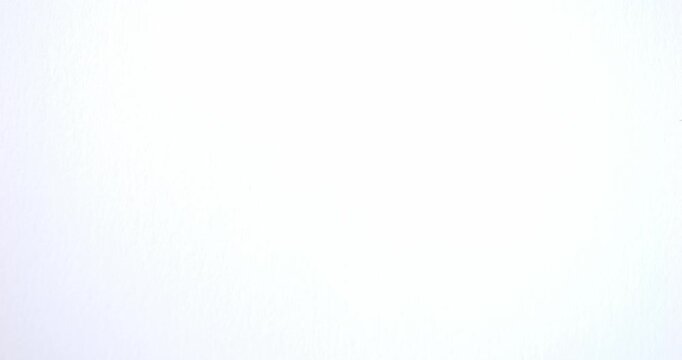 Black spots on a white background. Ink spills onto white paper. Black drops and white surface.