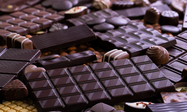 dark chocolate bars and candy background, delicious cocoa dessert.