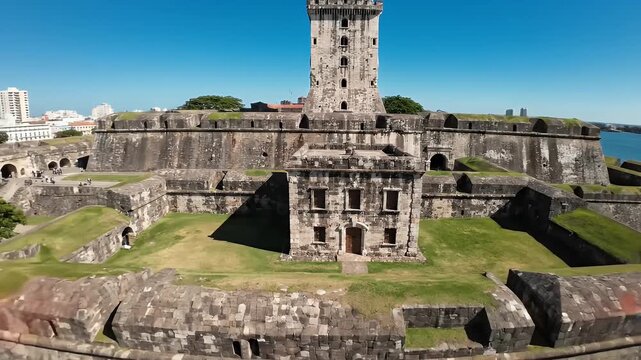 Castillo de San Felipe Tower During the Day - An aerial view showcases the imposing main tower and stone fortifications of Castillo de San Felipe during daylight hours, with green grass visible