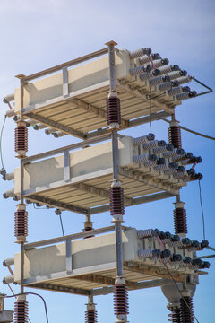 High-voltage capacitor bank modules at an electrical substation support reactive power compensation, grid stability, and utility reliability in outdoor energy systems.