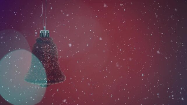 Animation of christmas red bell bauble decoration and snow falling on red background