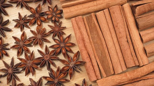 Macro flat lay of star anise and cinnamon sticks on a wooden board. Clean organic spice pattern for Asian culinary and traditional medicine concepts.
