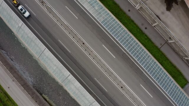 A bird's-eye view, captured by a stationary drone, of a Swiss motorway with two-way lanes