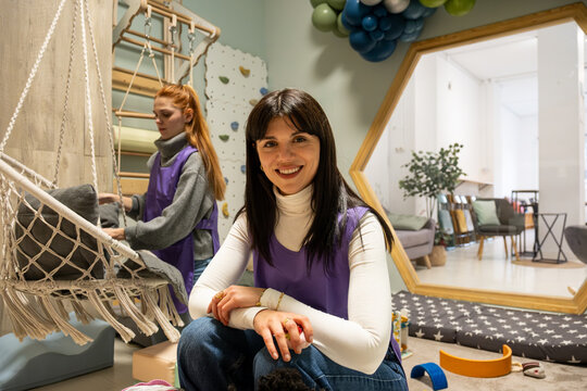 Happy teacher smiling while working in a bright, modern learning environment