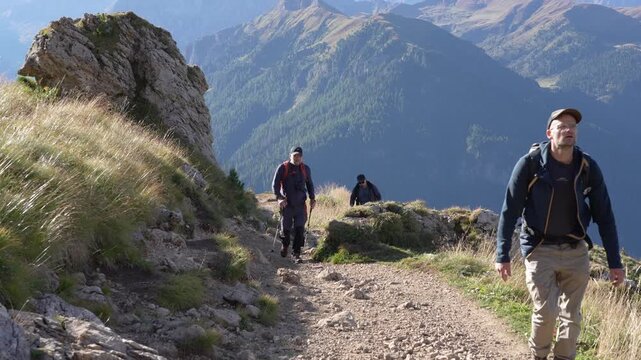 Tourists go for a walk along the trail around the Langkofel mountain range in the Dolomites.