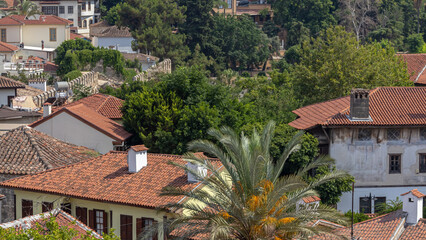 Naklejka premium Top view of the tiled roofs of the old town. Kaleici is a quarter in Antalya, located in the Muratpasha district. Historical city center in Antalya. The narrow streets of the old town.