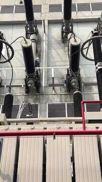 High voltage substation equipment and insulators at an electrical facility, showing power infrastructure for utility operations, preventive maintenance, safety checks, and grid reliability.