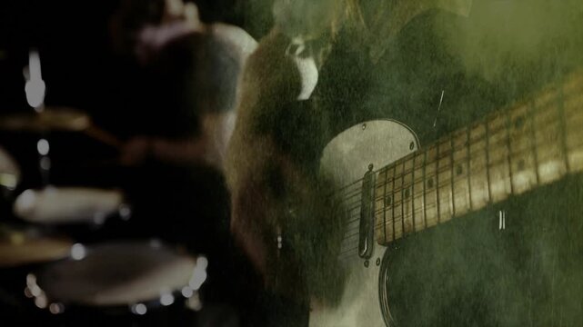 guitarist playing electric guitar on foggy music stage, with animated sound waves and music notes