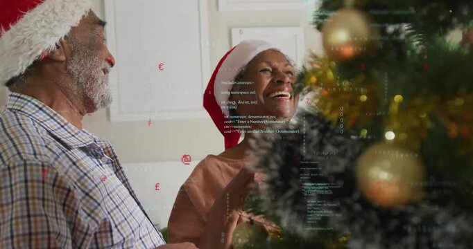 Laughing couple initiating Christmas tree decorating with animated baubles floating for holiday ad