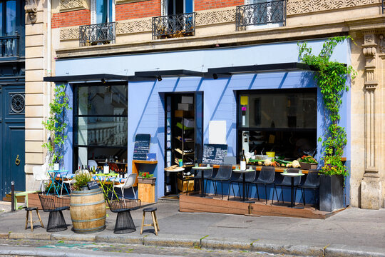 Cozy street with tables of cafe in quarter Montmartre in Paris, France. Architecture and landmarks of Paris. Postcard of Paris