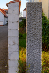 Naklejka premium Tall blocks stand side by side in a city area with green plants around during sunset time showing the difference in materials and styles