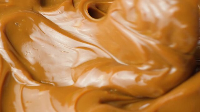 Boiled condensed milk texture or dulce de leche background