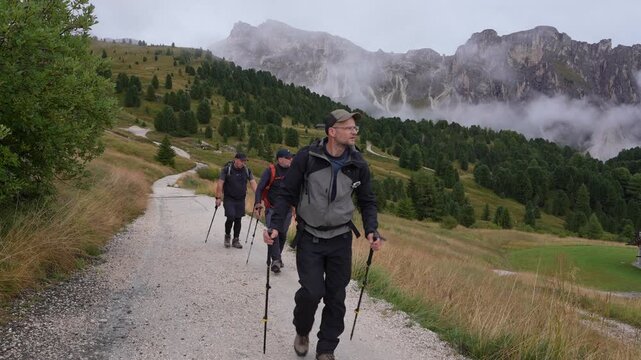 Tourists in Geisler National Park. Italy. Dolomites.