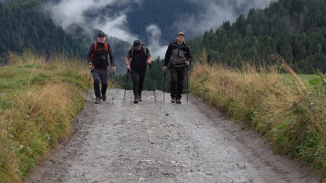 Hikers on a trek in the Geisler National Park. Italy. Dolomites.
