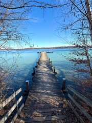 Fototapeta premium long wooden pier over the lake in the morning