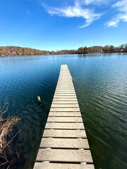 Fototapeta premium long wooden pier leading out of the lake