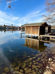 Fototapeta premium old wooden boat houses on the idyllic lake