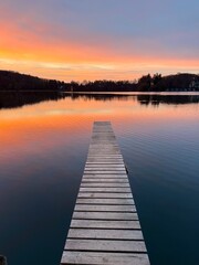 Fototapeta premium sunset over the lake with wooden pier