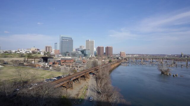 Richmond, Virginia city skyline at sunset, featuring the James River rapids and the downtown financial district. Elevated sunset video.