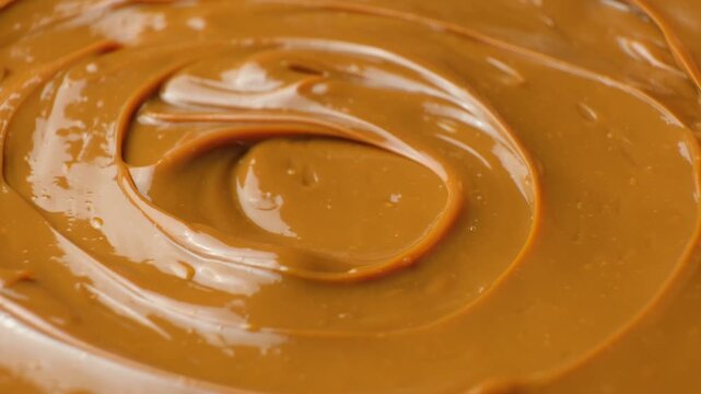 Boiled condensed milk texture or dulce de leche background