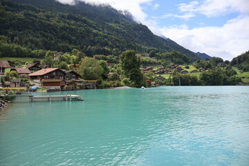 Obraz premium blue lake and green mountains with a Swiss house