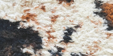 Close up of soft faux fur rug texture with brown black and white patterns © ZenVectors