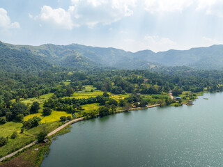 Obraz premium Natural Beauty of Panshet Backwaters with Agricultural Fields and Hills