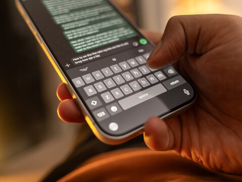 Man hands chatting and typing on smartphone macro closeup. Unrecognizable human typing text message tapping touchscreen keyboard using whatsapp application a social media
