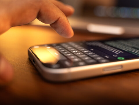 Man hands chatting and typing on smartphone macro closeup. Unrecognizable human typing text message tapping touchscreen keyboard using whatsapp application a social media