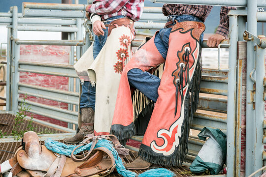 Taos, New Mexico, USA. Detailed view of western chaps and cowboy boots at rodeo arena