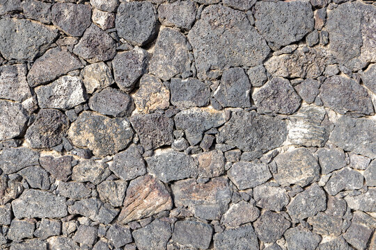 historic seamless volcano stone wall in grey as background