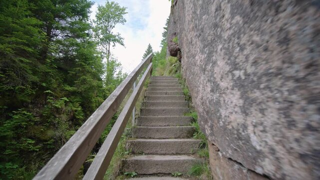 Walking up Menzenschwander Waterfall cascade stairs in Black Forest Mountain Range Germany Schwarzwald