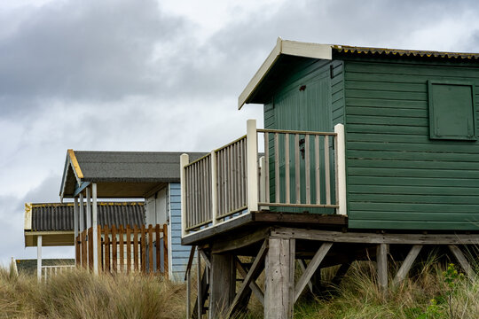 Traditional wooden beach huts in the sand dunes on Old Hunstanton beach on the North Norfolk Coast