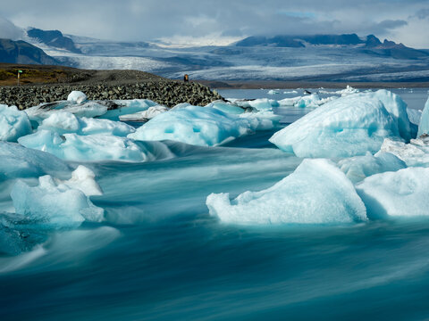 Icebergs flowing into the ocean along the narrow strait from Iceland's Jokulsarlon Glacier Lagoon, long exposure