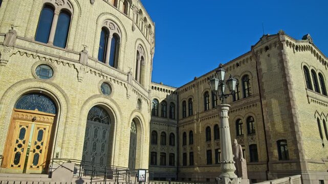 Close view of ornate facade of the Norwegian Parliament building in Oslo. Historic architecture, arches and detailed stonework during summer in Norway.