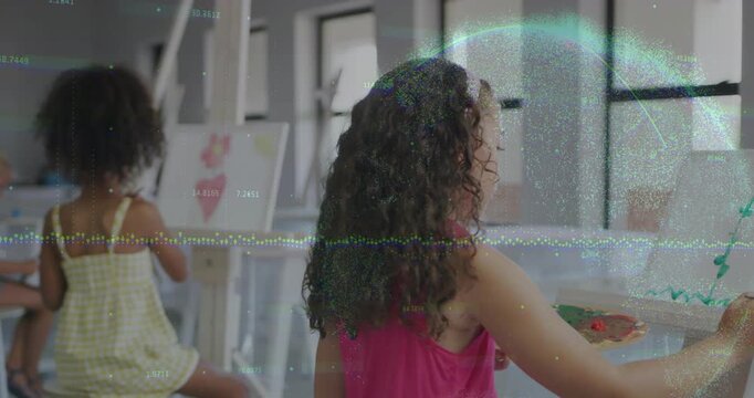 Vertical video: Painting girl in pink top painting green at easel in art class, camera pulling back