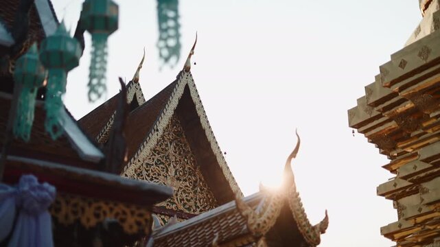 Sunlight shining over a beautiful ornate buddhist temple roof in chiang mai, thailand