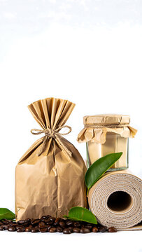 Coffee beans in brown paper bag alongside jar and paper roll for sustainable product concept and minimalist presentation