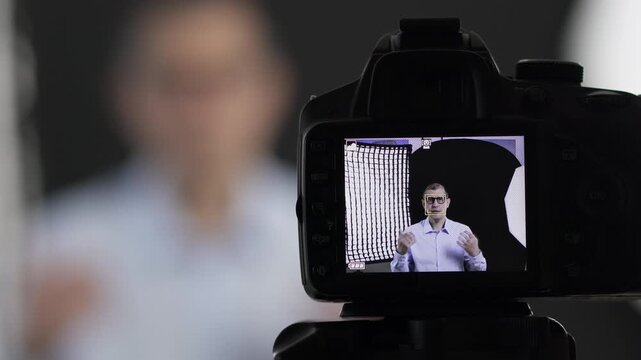 Camera, filming and live streaming with man in studio for social media, content creation and vlogger. Subscription channel, virtual interview and viral with mature person and recording for broadcast