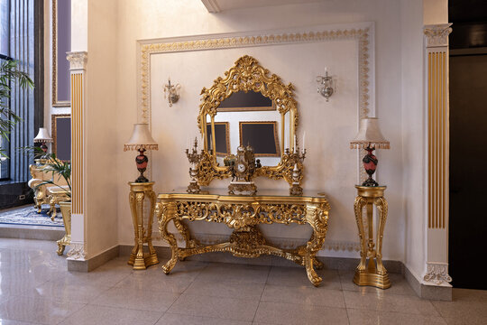 Hotel lobby, classical interior with golden furniture and ornate mirror